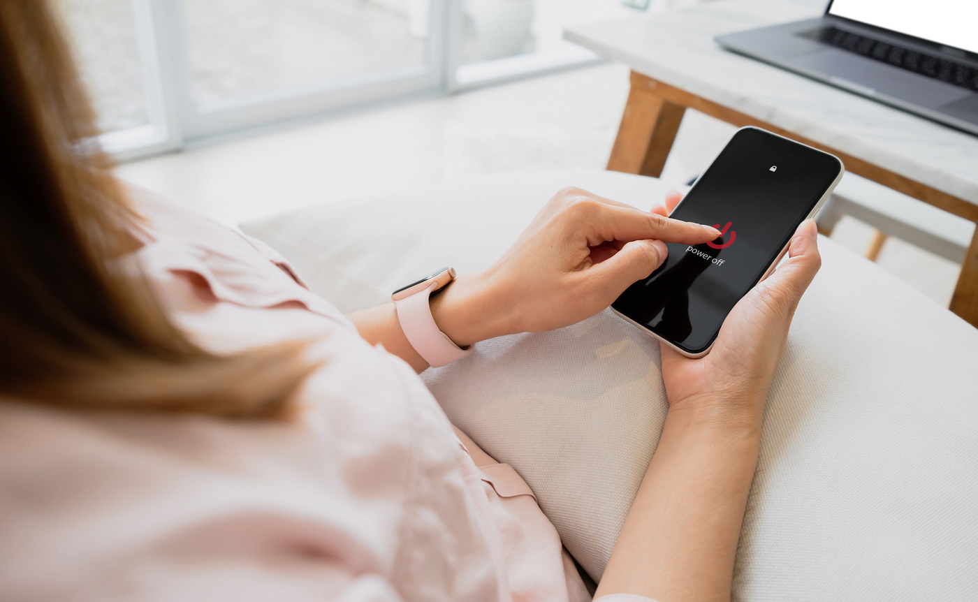 Woman hand using is sliding to turn off the mobile phone to redu