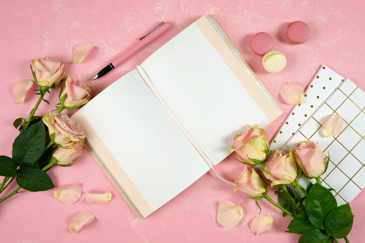 Desktop workspace journal mockup flatlay, blush pink roses on pink background.